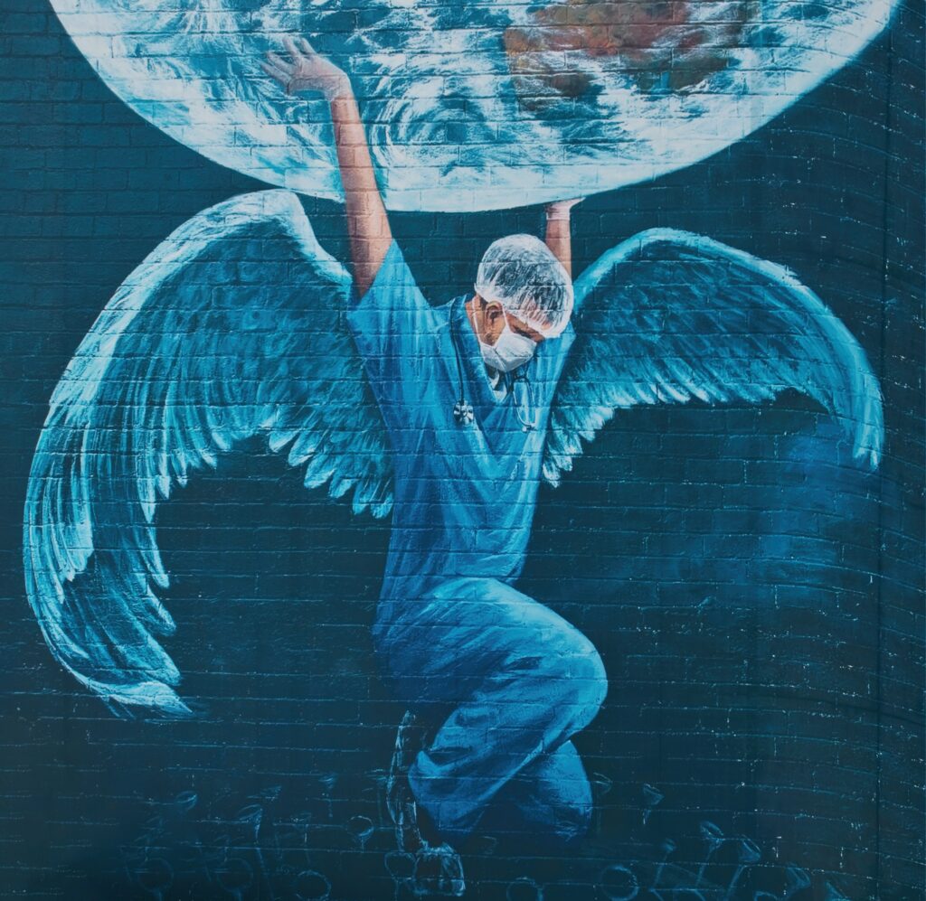 Healthcare worker holding up planet