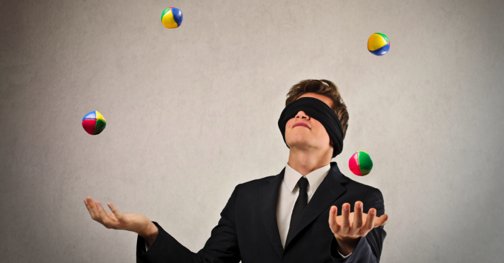 blindfolded man juggling